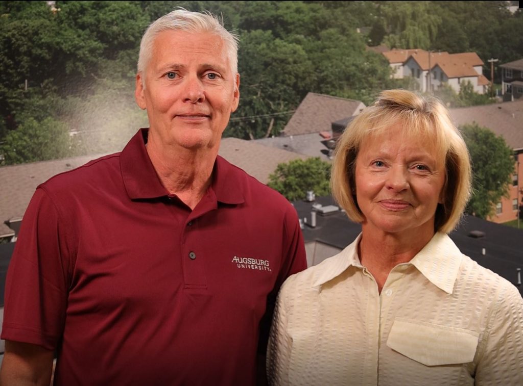 Dennis and Bev stand next to each other smiling for the photo